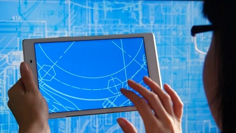 A female engineer holds a tablet with a schedule, analyzes and develops the Stock Footage 120556519