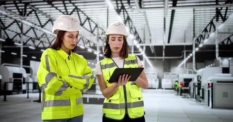 Female engineer inspects factory using tablet Stock Photos