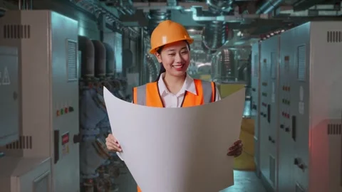 Female Engineer Looking At Blueprint In Her Hands In Engine Control Room Stock Footage 292368617