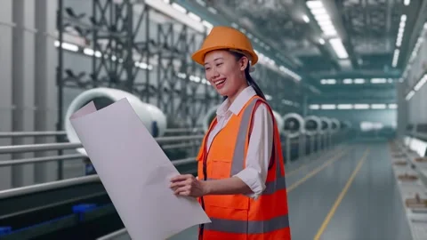Female Engineer Looking At Blueprint In Her Hands, Aircraft Engine Factory Stock Footage 314608041