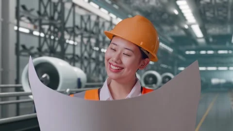 Female Engineer Looking At Blueprint In Her Hands, Aircraft Engine Factory Stock Footage 314608628