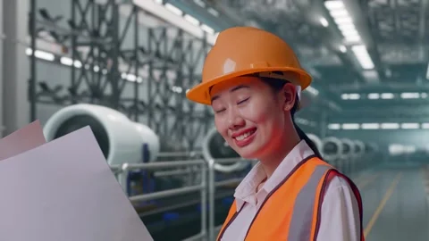 Female Engineer Looking At Blueprint In Her Hands, Aircraft Engine Factory Stock Footage 314608826