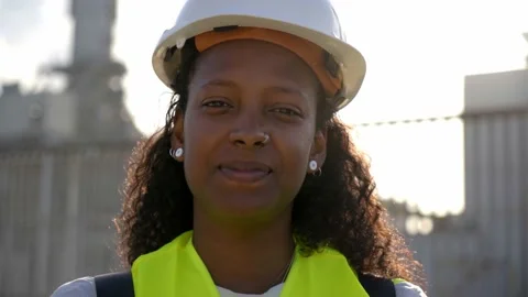 Female engineer looking at camera carefree wearing protective clothing standing Stock Footage 224965952