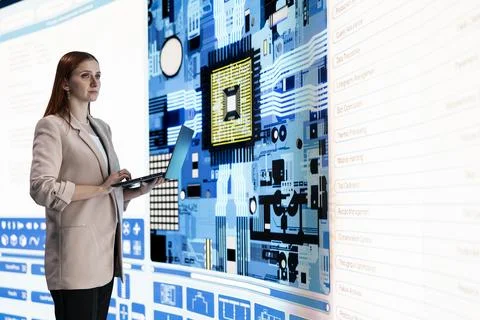 Female engineer looking at digital circuit board with microchip components Stock Photos