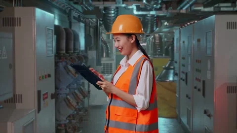 Female Engineer Looking At The Tablet In Her Hand In Engine Control Room Stock Footage 292368736