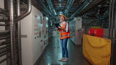Female Engineer Looking At The Tablet In Her Hand In Engine Control Room Stock Footage 292371776