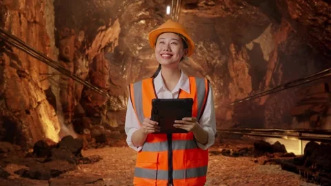 Female Engineer Looking At The Tablet In Her Hand In Mine Tunnel Stock Footage 299574321