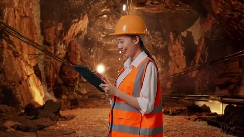 Female Engineer Looking At The Tablet In Her Hand In Mine Tunnel Stock Footage 299574732
