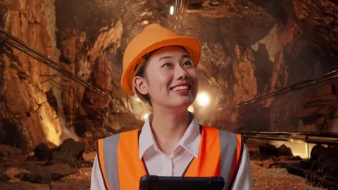 Female Engineer Looking At The Tablet In Her Hand In Mine Tunnel Stock Footage 299576078