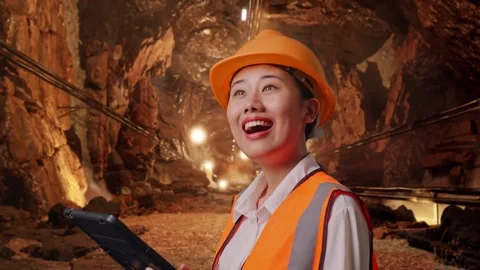 Female Engineer Looking At The Tablet In Her Hand In Mine Tunnel Stock Footage 299577312