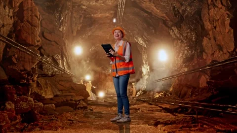 Female Engineer Looking At The Tablet In Her Hand In Mine Tunnel Stock Footage 299580392