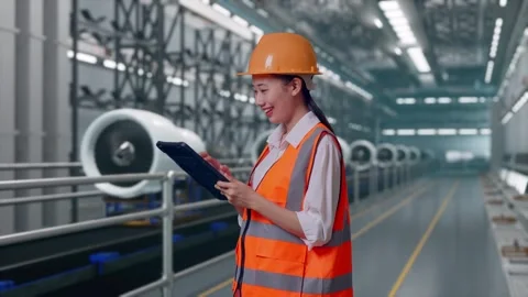 Female Engineer Looking At The Tablet In Her Hand, Aircraft Engine Factory Video stock 314607972