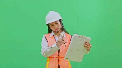 Female Engineer Measuring Scale with Fingers on Clipboard Green Screen Video stock 331627149