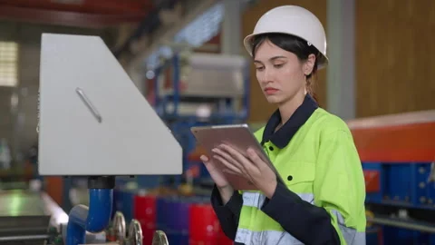 Female engineer meticulously inspected the complex workings of the machine. Video stock 241466035