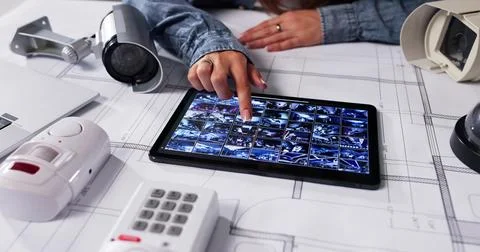Female Engineer Monitors Office Security System With Live Surveillance Footag Stock Photos