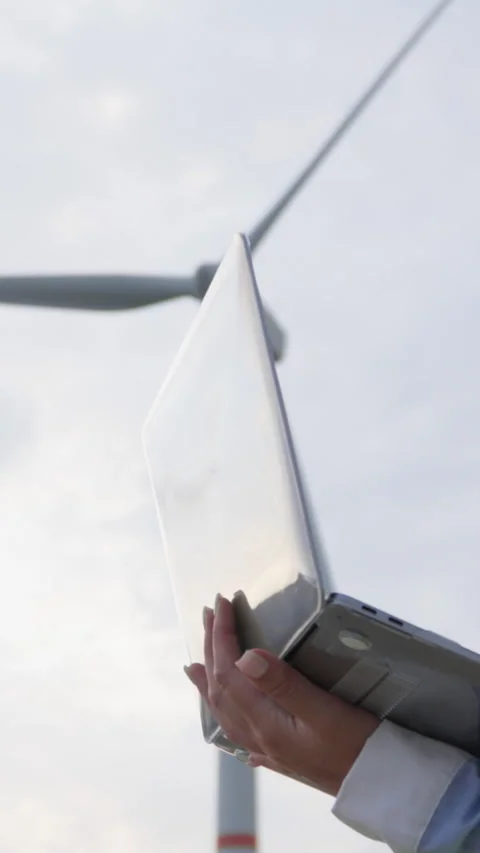 A female engineer observes the operation of a wind turbine, monitoring the Video stock 272312849