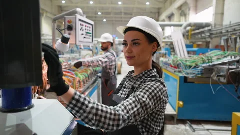 Female engineer operating CNC machine in window factory Stock Footage 314584120