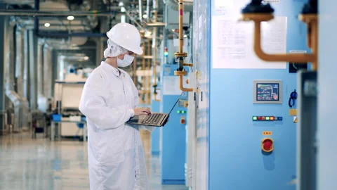 Female engineer is operating control panels of the factory cabinets Stock Footage 168140034