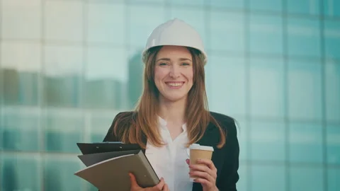 Female Engineer or Architect Wearing a White Helmet Holding Documents Stock Footage 236264012