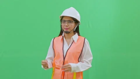 Female Engineer Pointing at Imaginary Safety Sign Green Screen Vídeos de archivo 331864894