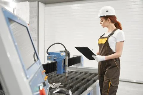 Female engineer in process of controlling plasma cutting Stock Photos