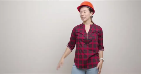 Female engineer puts on her helmet for safety Stock Footage 280867456