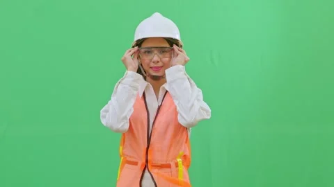 A female engineer putting on transparent safety goggles Video stock 332057565