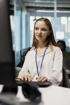 Female engineer reviewing code snippets in modern workplace Stock Photos