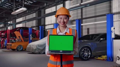 Female Engineer Showing Green Screen Laptop in Auto Repair Shop Stock Footage 313528037