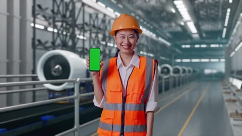 Female Engineer Showing Green Screen Smartphone, Aircraft Engine Factory Stock Footage 314607878