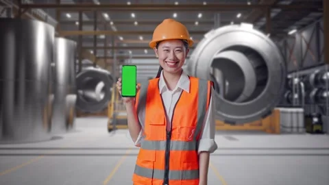 Female Engineer Showing Green Screen Smartphone at Heavy Factory Stock Footage 340823589