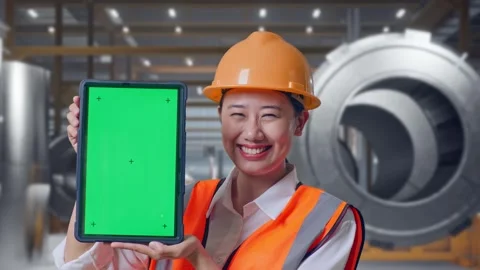 Female Engineer Showing Green Screen Tablet at Heavy Factory 動画素材 340825061