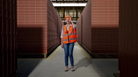 Female Engineer Showing Ok Hand Sign Over Eye With Brick In Stacks Stock Footage 303762996
