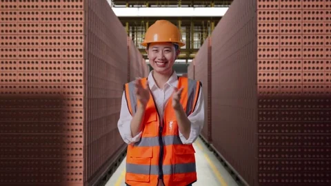 Female Engineer Smiling And Clapping Her Hands With Brick In Stacks Stock Footage 303762275