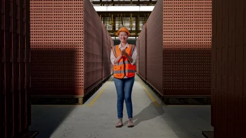 Female Engineer Smiling And Clapping Her Hands With Brick In Stacks Stock Footage 303763366