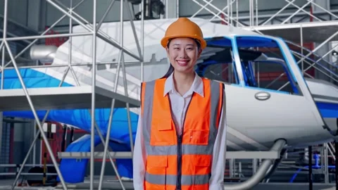 Female Engineer Smiling and Inspecting Helicopter Stock Footage 312126884