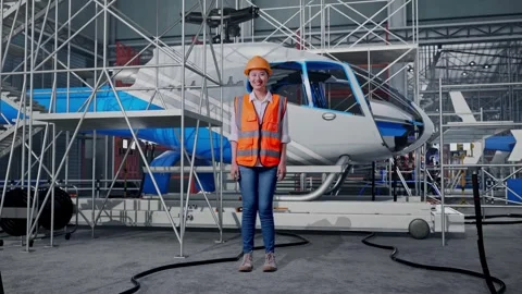 Female Engineer Smiling and Inspecting Helicopter Stock Footage 312127376
