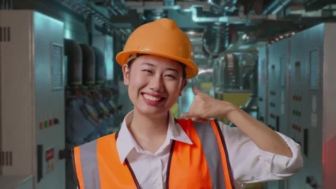 Female Engineer Smiling And Making Call Me Gesture In Engine Control Room Stock Footage 292369143