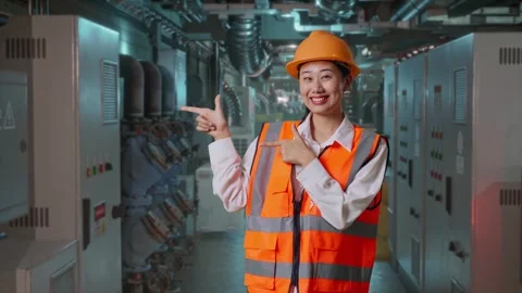 Female Engineer Smiling And Pointing To Side In Engine Control Room Stock Footage 292368357