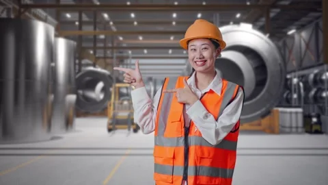 Female Engineer Smiling And Pointing To Side at Heavy Factory 動画素材 340822659
