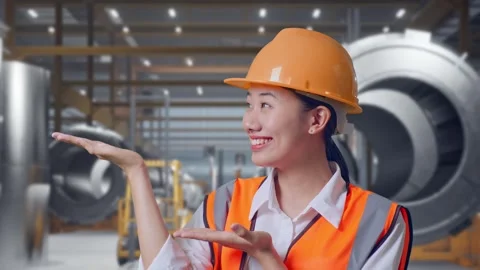 Female Engineer Smiling And Pointing To Side at Heavy Factory Stock Footage 340824831