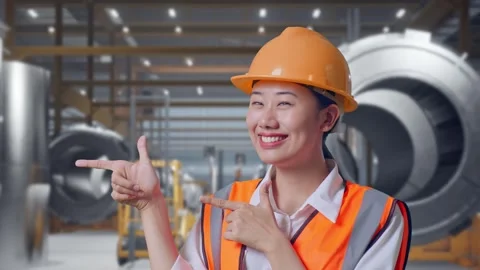 Female Engineer Smiling And Pointing To Side at Heavy Factory Stock Footage 340824855