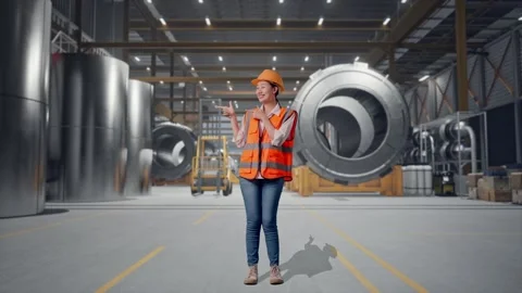 Female Engineer Smiling And Pointing To Side at Heavy Factory Stock Footage 340825782