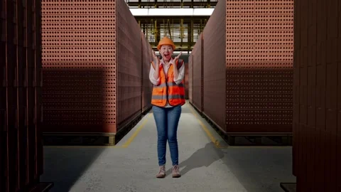 Female Engineer Smiling And Saying Wow With Brick In Stacks Stock Footage 303762897