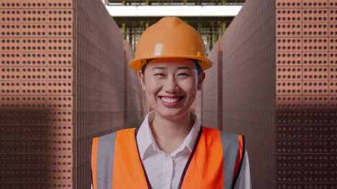 Female Engineer Smiling With Brick In Stacks Stock Footage 303762277