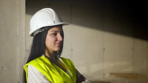 Female engineer smiling at construction site. Self-confident Stockbeeldmateriaal 240336724