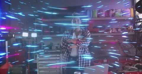 Female engineer standing arms crossed in tech workshop, with neon streaks Stock Footage 329708176