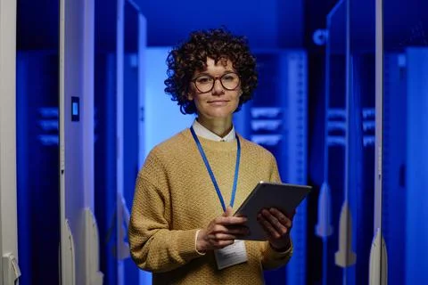 Female engineer standing at server room Stock Photos