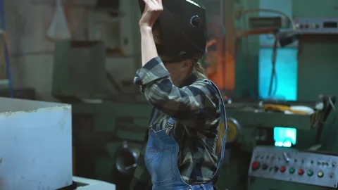 A female engineer supervises the production process at the factory Stock Footage 154580127