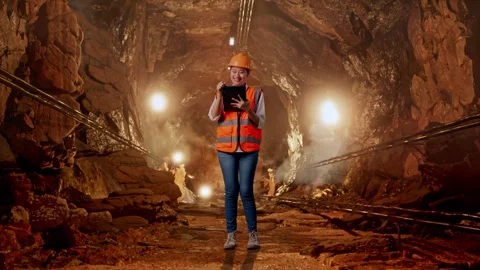 Female Engineer Taking Note On The Tablet In Mine Tunnel Stock Footage 299579486